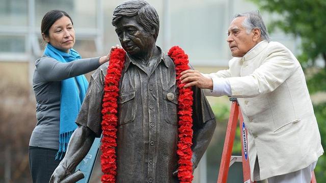 Julie Chavez Rodriguez, granddaughter of civil rights leader Cesar Chavez, and Fresno State emeritus faculty member Dr. Sudarshan Kapoor, place a garland around the statue of Cesar Chavez in 2018. The statue was placed in storage after it was revealed that Chavez sexually abused girls and young women. Julie Chavez Rodriguez, granddaughter of civil rights leader Cesar Chavez, and Fresno State emeritus faculty member Dr. Sudarshan Kapoor, place a garland around the statue of Cesar Chavez in 2018. The statue was placed in storage after it was revealed that Chavez sexually abused girls and young women.